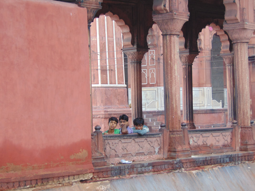 Indian men and boys staring out of mosque