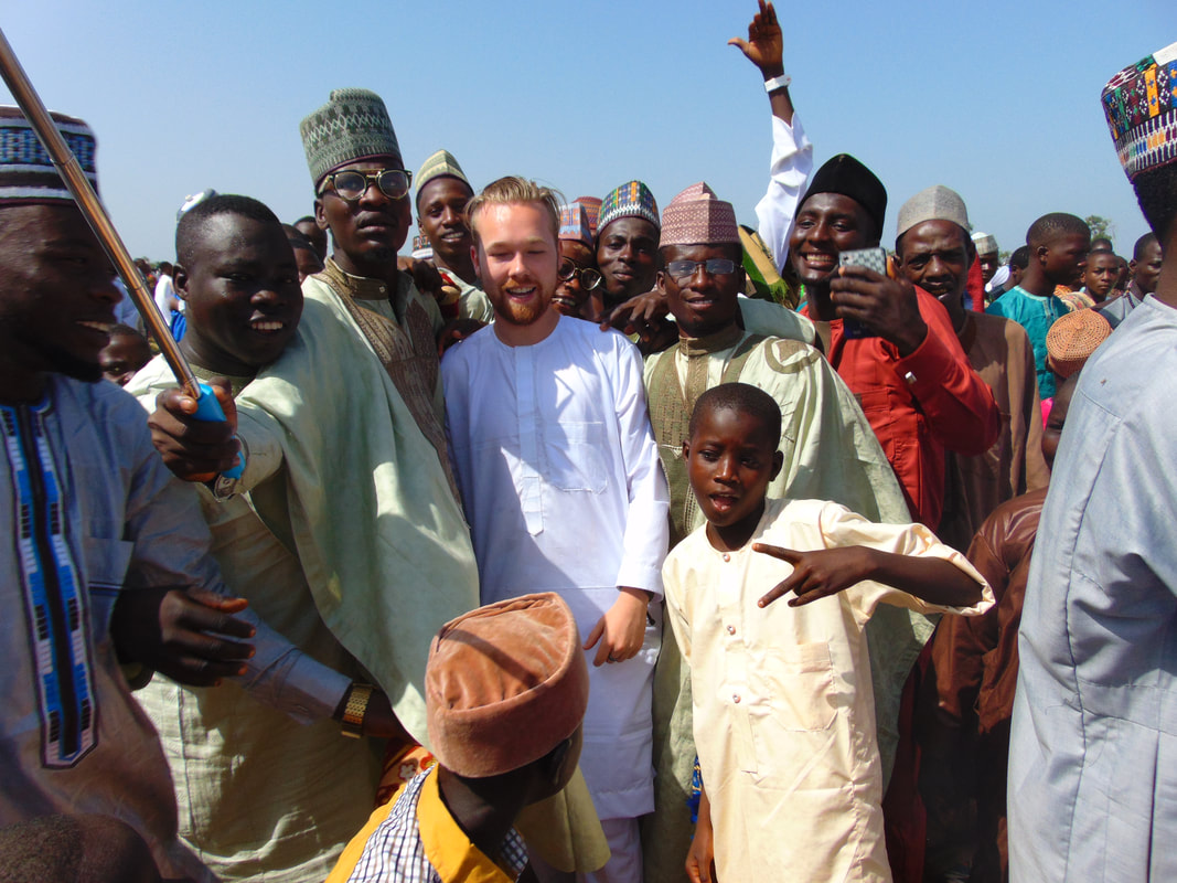VSO Volunteer and local men wearing Kaftan's for Eid